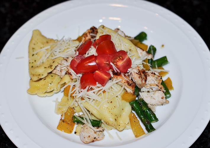 Chicken ravioli with tomato pepper and asparagus