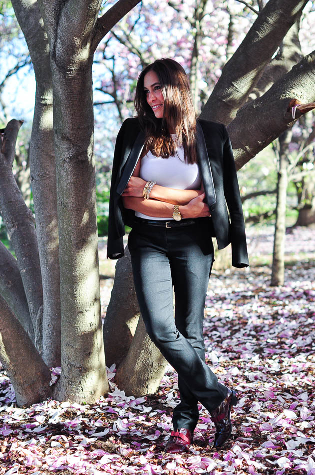 woman wearing Womens black tuxedo suit and leaning on a tree