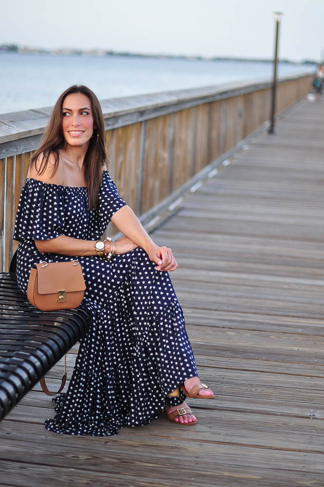 woman sitting and wearing French Hen Maxi LOFT sitting on bench