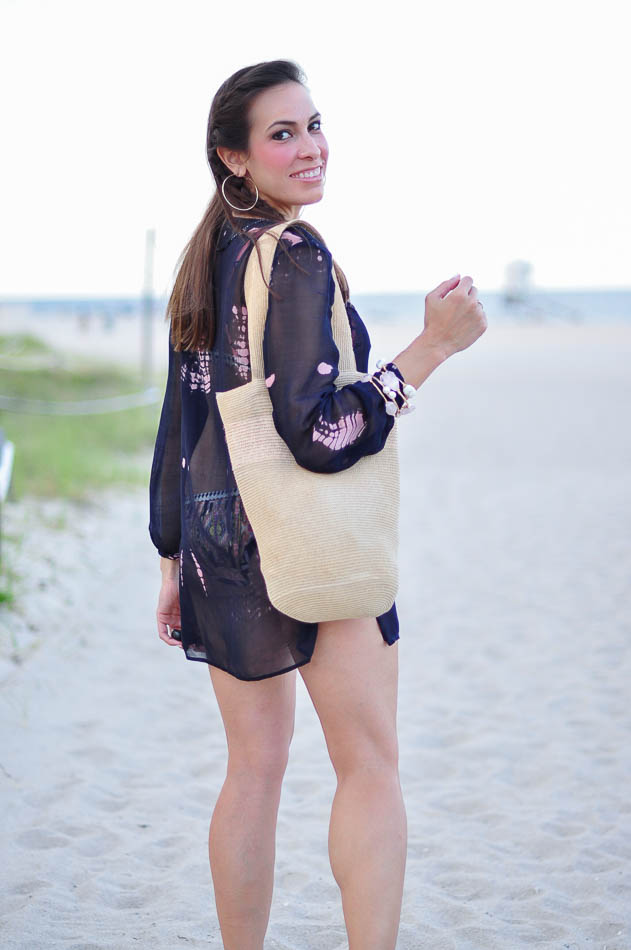 woman at the beach wearing a coverup from zara woman at the beach wearing a coverup from zara