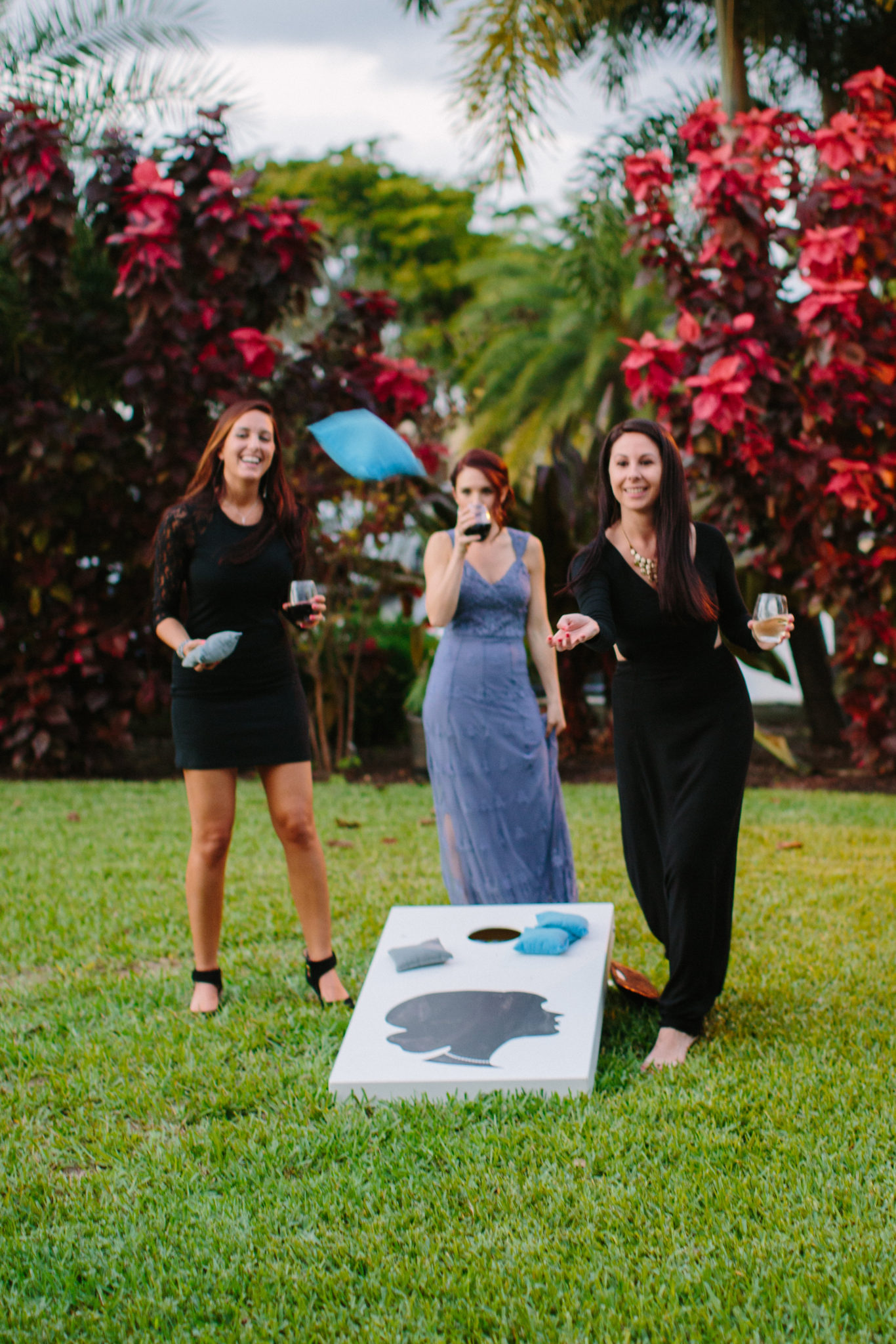 Wedding guests playing corn hole