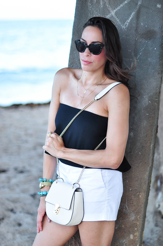 A Glam Lifestyle blogger leaning on a column