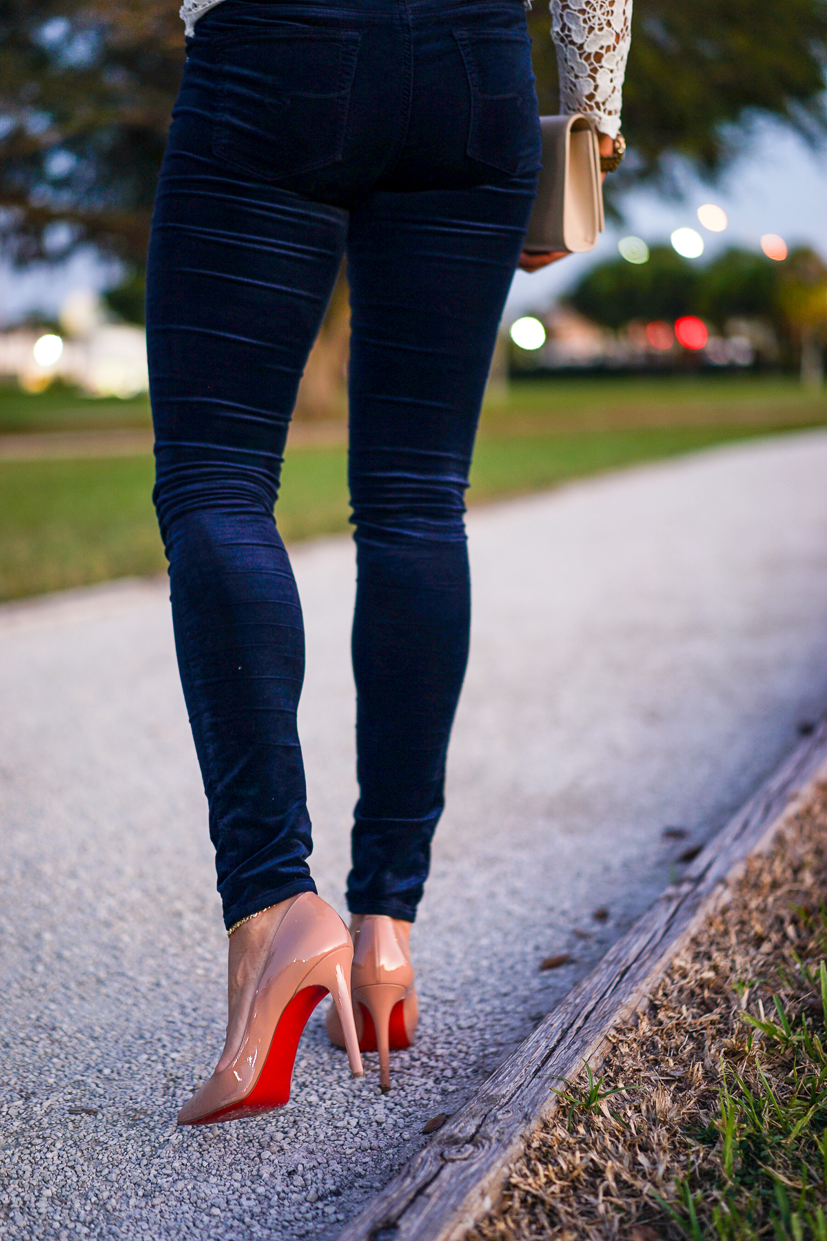 A Glam Lifestyle blogger Amanda Mercado wearing nude Christian Louboutin heels and AG Jeans blue velvet legging pant
