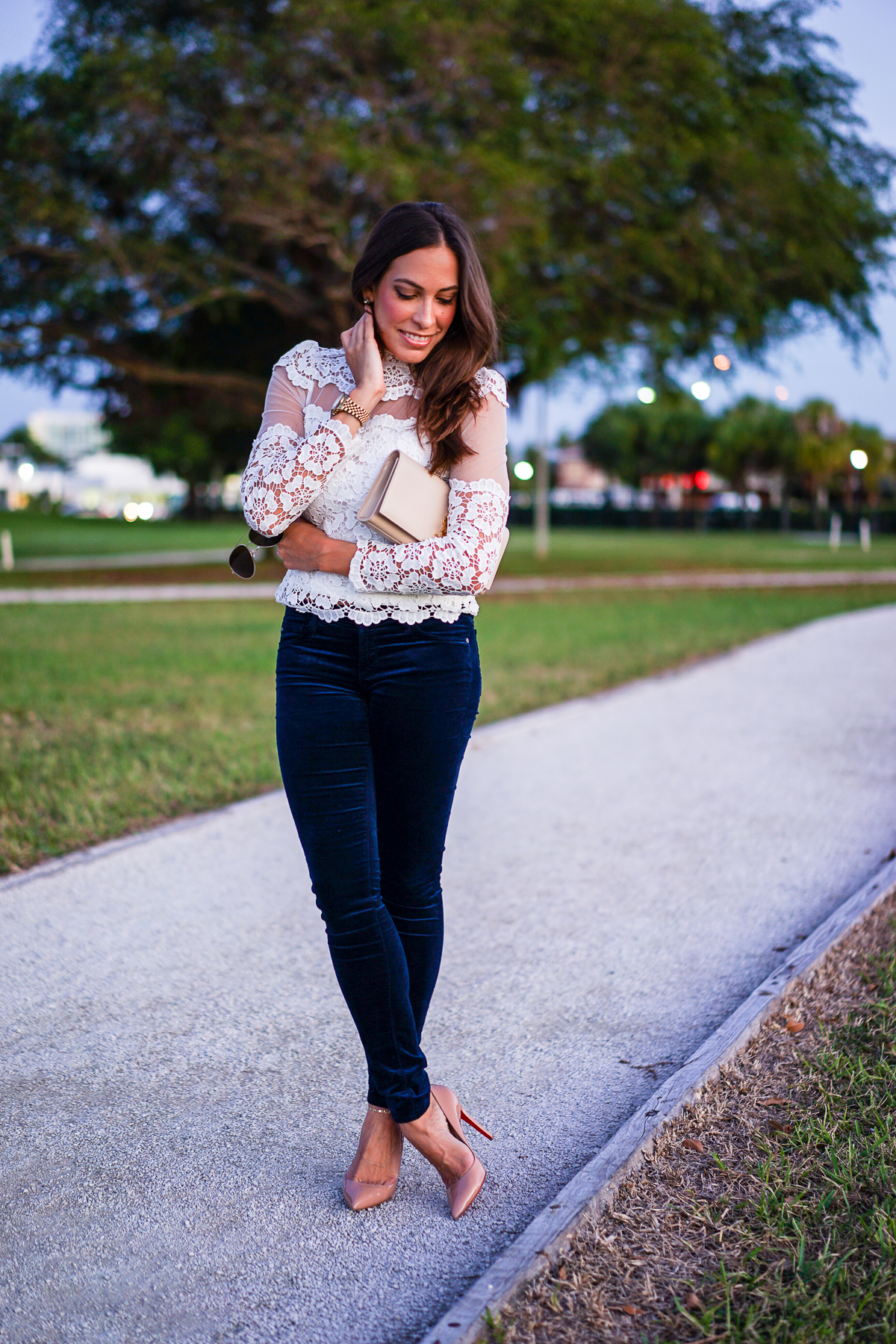 A Glam Lifestyle blogger wearing blue velvet leggings by AG Jeans with white Chicwish lace top and YSL monogram clutch