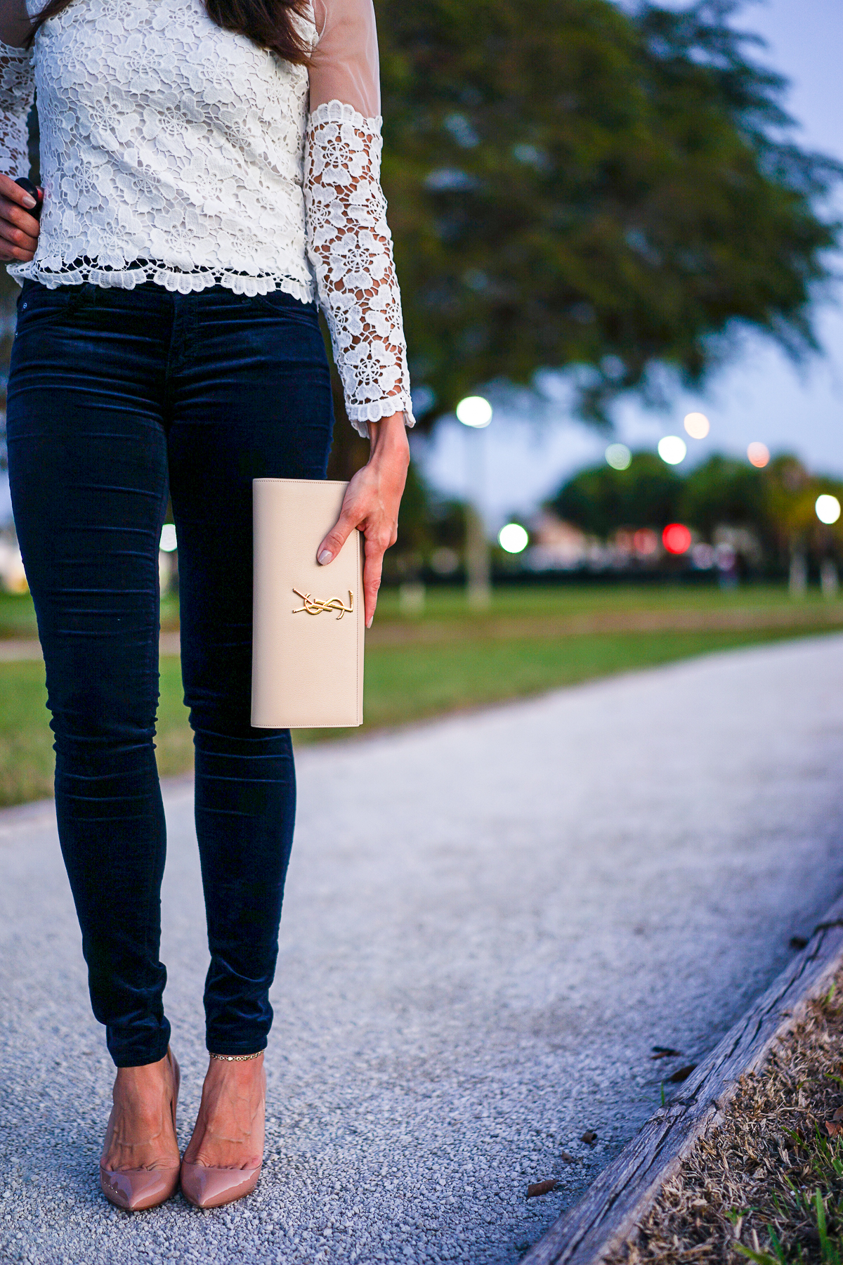 A Glam Lifestyle blogger Amanda Mercado wears AG Jeans blue velvet legging with nude YSL monogram clutch