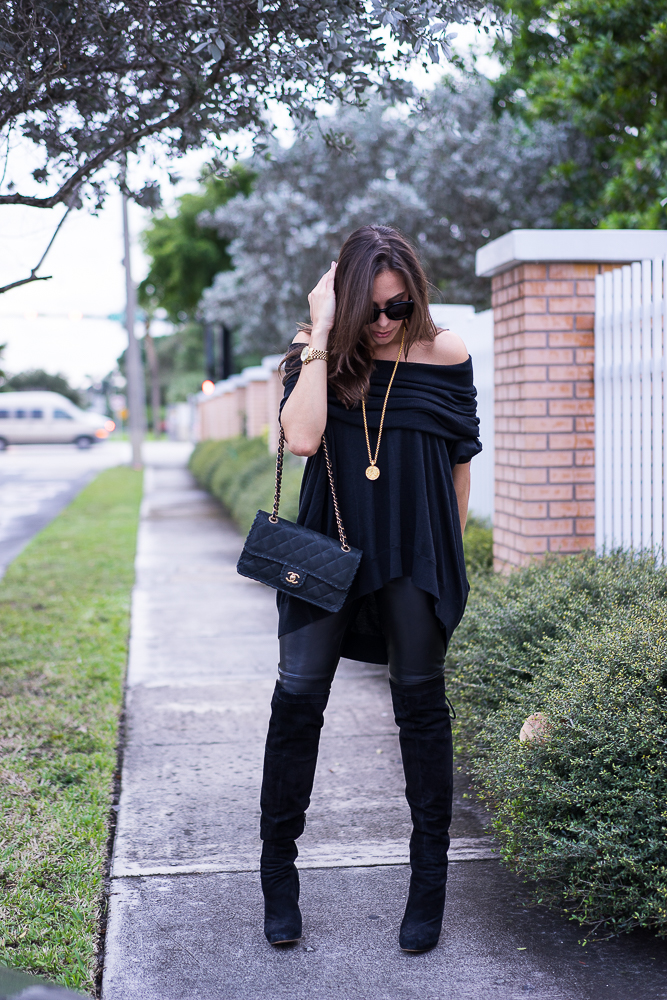 Black cashmere sweater and Chanel classic bag