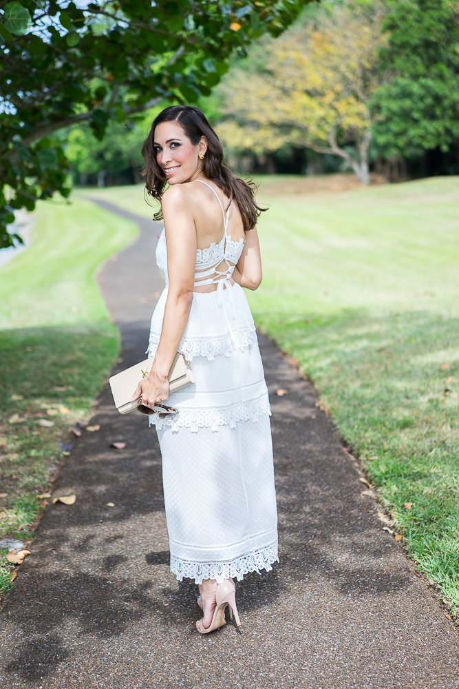 woman wearing white dress and YSL monogram nude clutch
