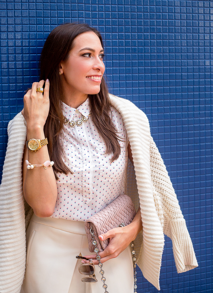 A Glam Lifestyle Blogger Amanda Champion sharing How to Go from Work to Cocktails - in photo: Amanda wearing Ann Taylor sleeveless top, Miu Miu Nappa crystal bag, JCrew white skirt, and sweater