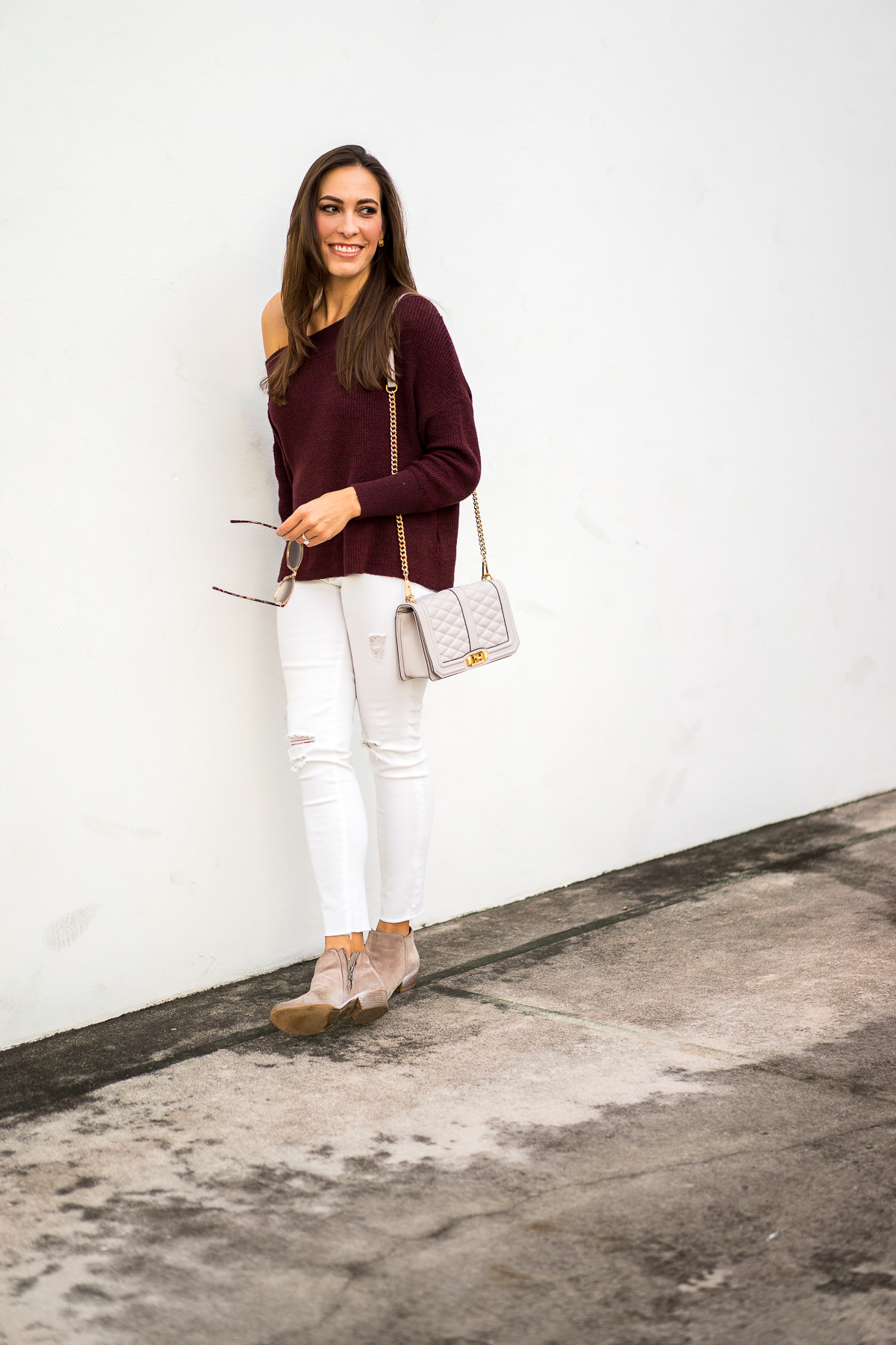 A Glam Lifestyle blogger Amanda Mercado in fall fashion favorites including Free People Alana slouchy dolman sleeve sweater and taupe ankle booties