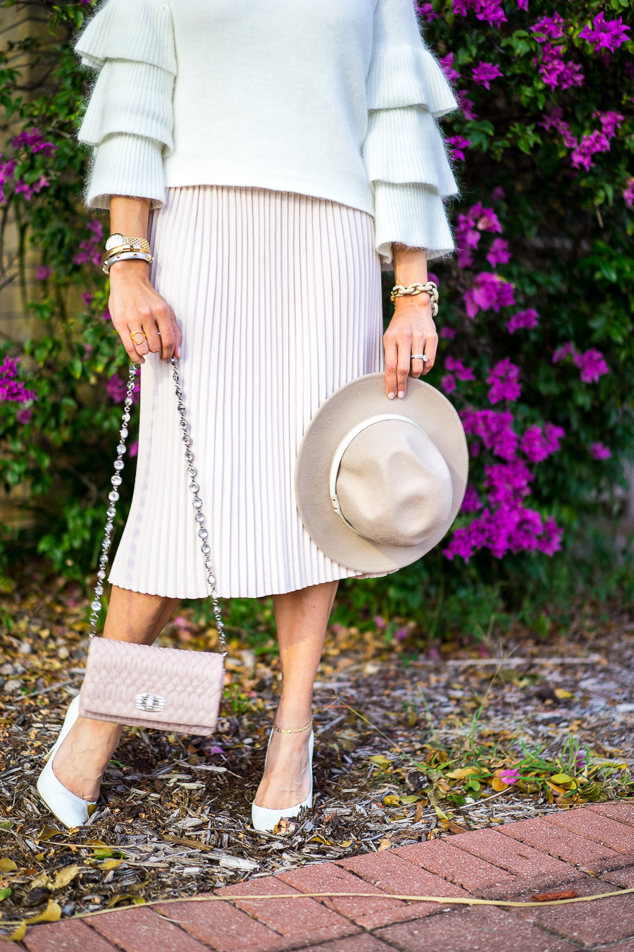 A Glam Lifestyle fashion blogger wearing Endless Rose tiered sleeve sweater and blush pleated midi skirt with Miu Miu bag and white pumps