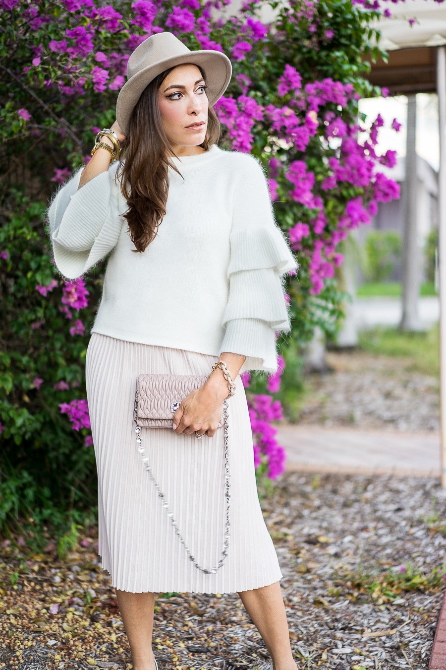 A Glam Lifestyle fashion blogger wearing Endless Rose tiered sleeve sweater and blush pleated midi skirt with Miu Miu bag and white pumps