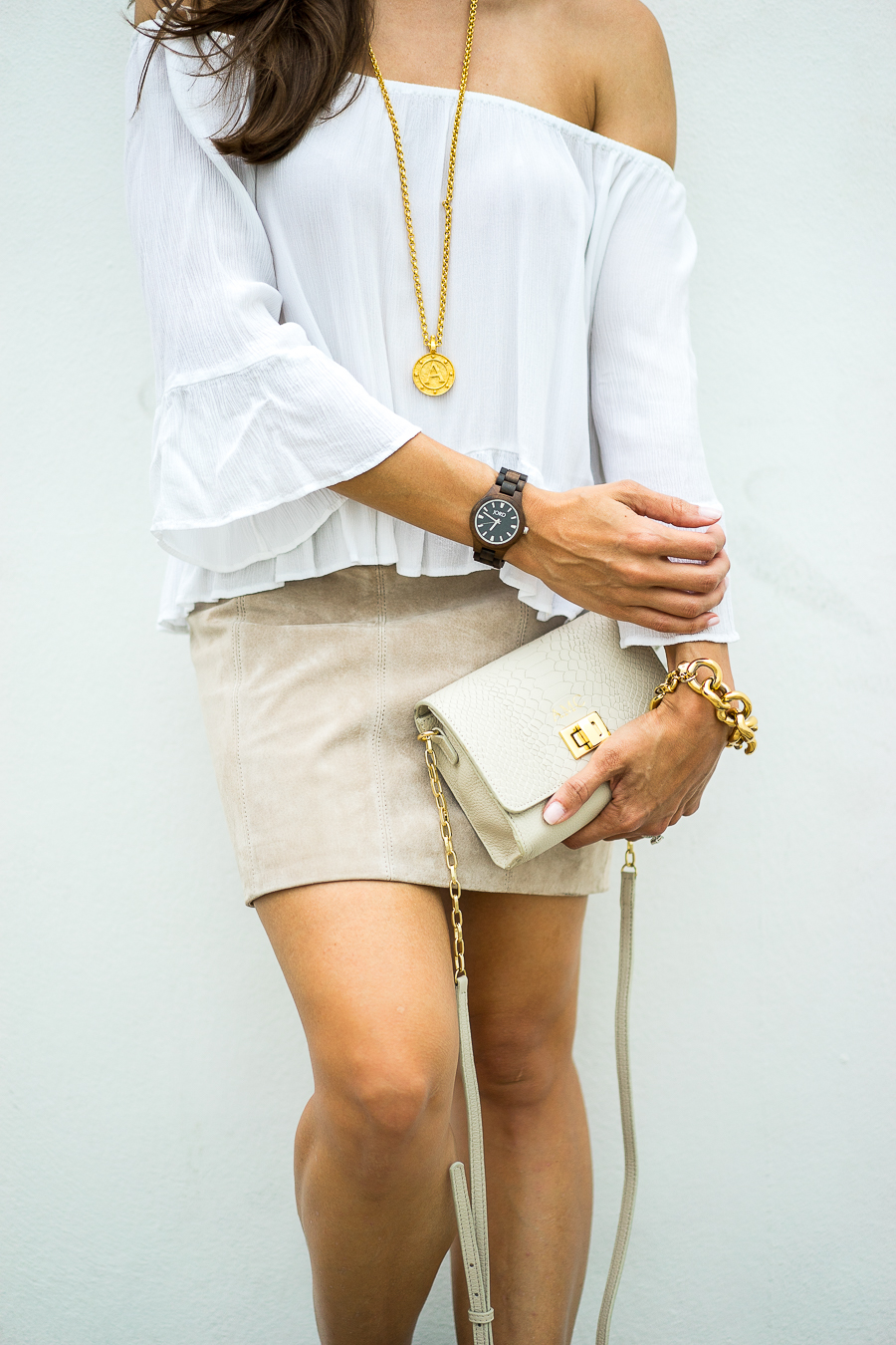 A Glam Lifestyle Blogger Amanda Champion shares JORD Wood Watch + Giveaway - in photo: Amanda wearing a white offshoulder top, brown skirt, and holding a clutch 