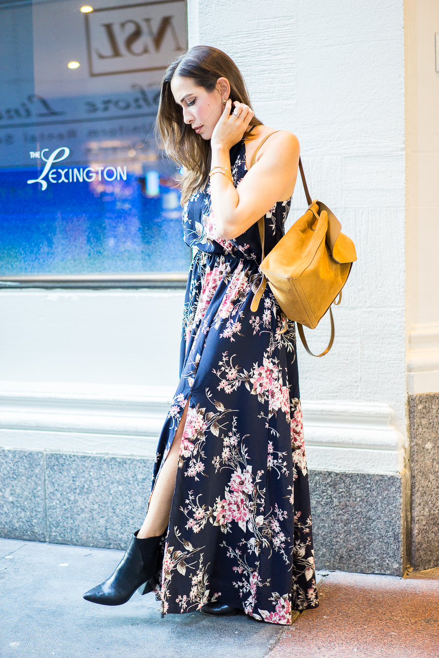 a glam lifestyle blogger wearing lulus floral maxi dress with aska collection troy booties and loeffler randal backpack