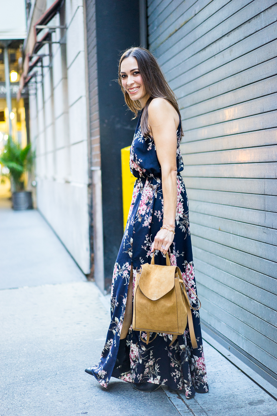 a glam lifestyle blogger wearing lulus floral maxi dress with aska collection troy booties and loeffler randal backpack