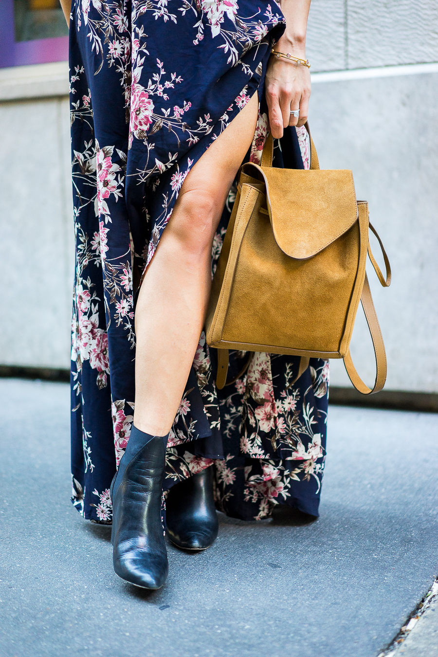 a glam lifestyle blogger wearing lulus floral maxi dress with aska collection troy booties and loeffler randal backpack