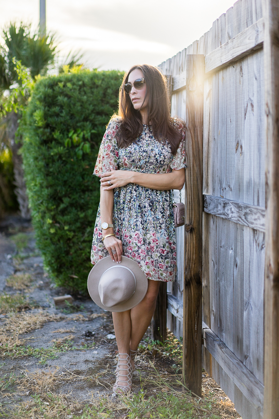 A Glam Lifestyle fashion blogger wearing Zara floral dress with Miu Miu bag showing her summer style with fall florals in a floral lace dress