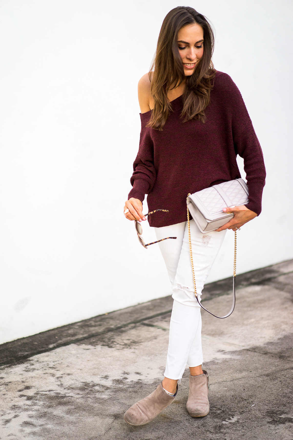 A Glam Lifestyle blogger wearing fall fashion trends like this Free People slouchy dolman sleeve sweater in burgundy