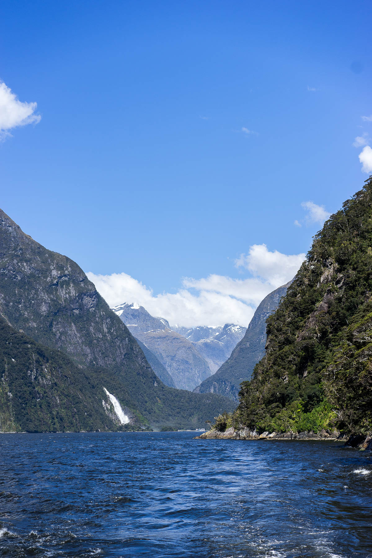 A Glam Lifestyle blogger Amanda takes in waterfalls at Milford Sound fiord on cruise in New Zealand