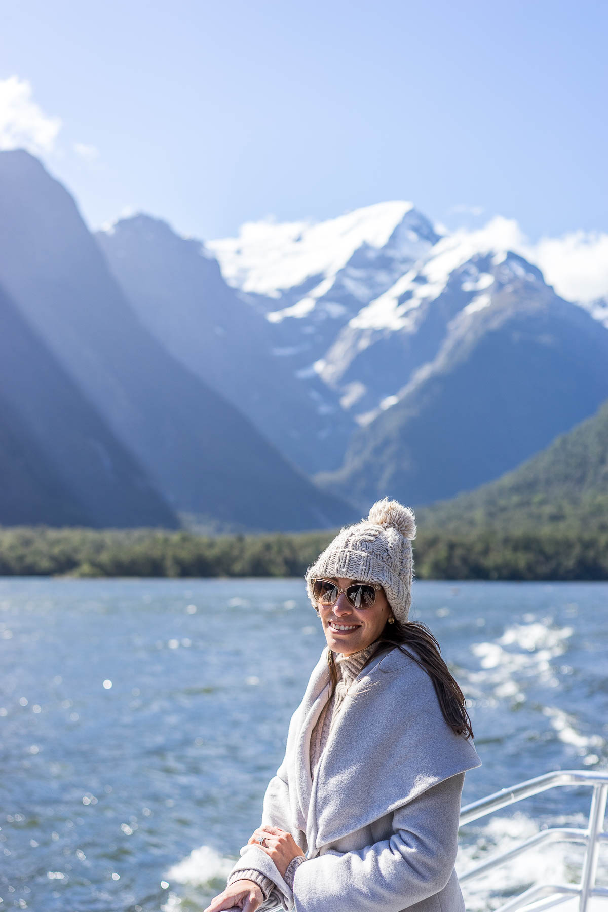 Fashion blogger Amanda from A Glam Lifestyle wears T Tahari marla coat on Milford Sound Cruise in New Zealand