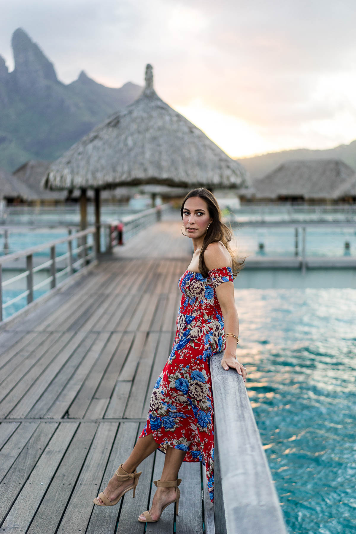 Fashion blogger Amanda from A Glam Lifestyle takes in the sunset at St Regis Bora Bora Resort in Auguste the Label floral maxi dress