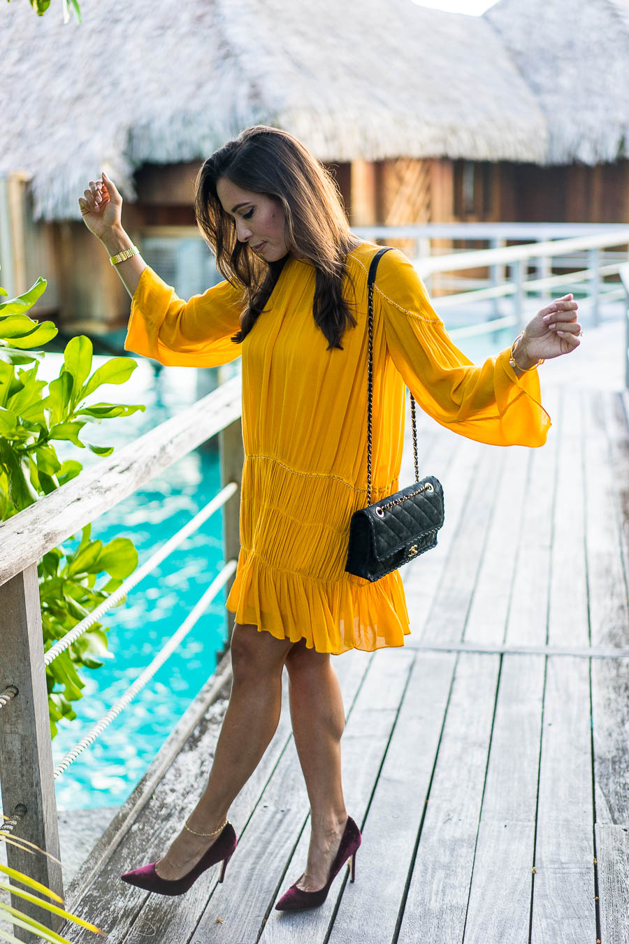 A Glam Lifestyle shares what she wore including this mustard yellow dress on her her honeymoon in Bora Bora