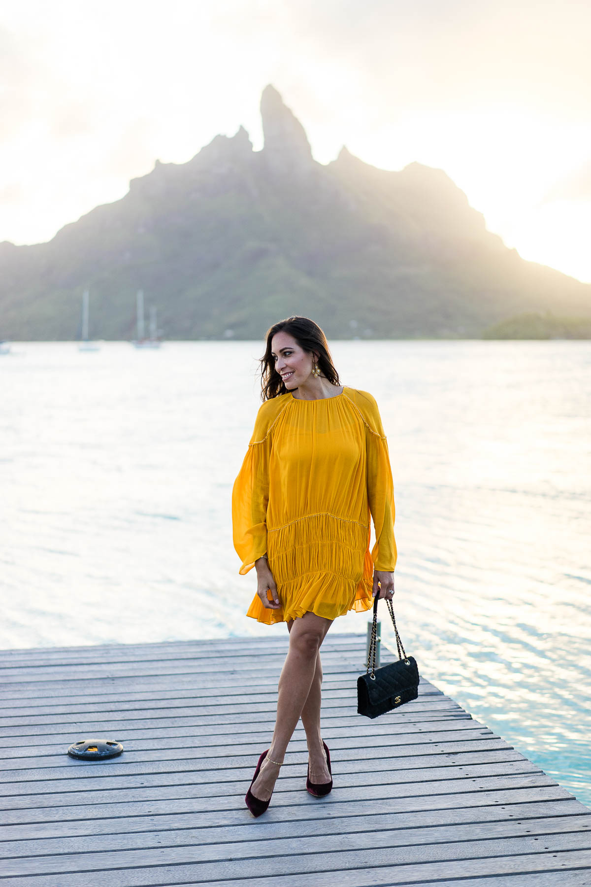 South Florida blogger Amanda from A Glam Lifestyle wears mustard yellow dress to dinner in Bora Bora