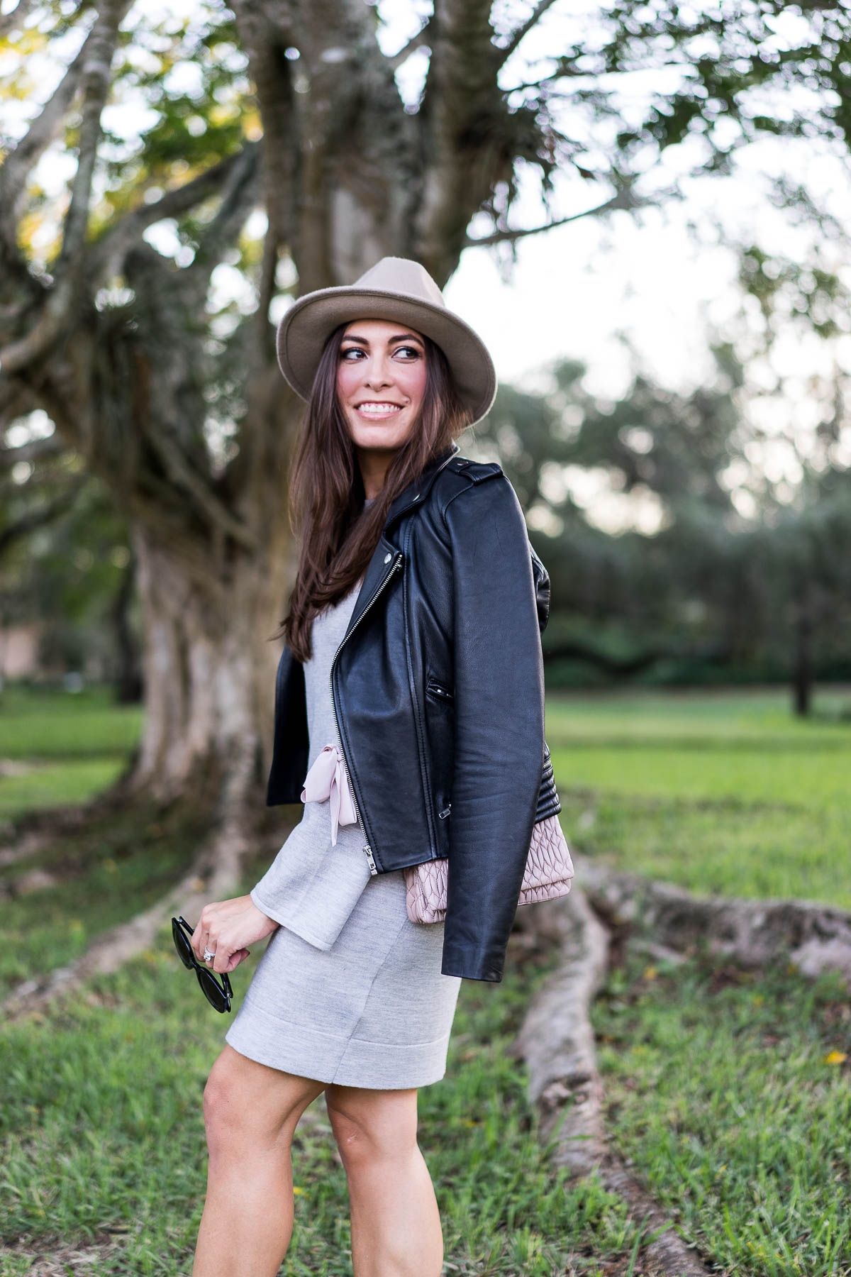 Amanda from A Glam Lifestyle shares her new years resolutions for style and the blog while wearing Club Monaco Sohrab sweater dress and Maje black leather moto jacket