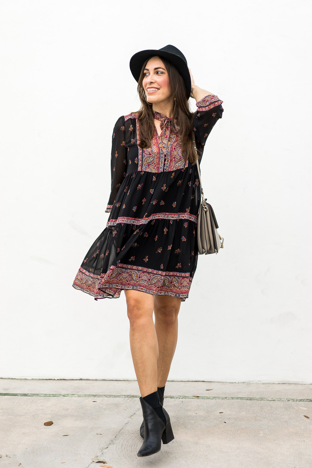 A Glam Lifestyle blogger Amanda favors boho midi dresses like the Joie Alpina dress and accessorizes with black ankle booties and Rag and Bone fedora