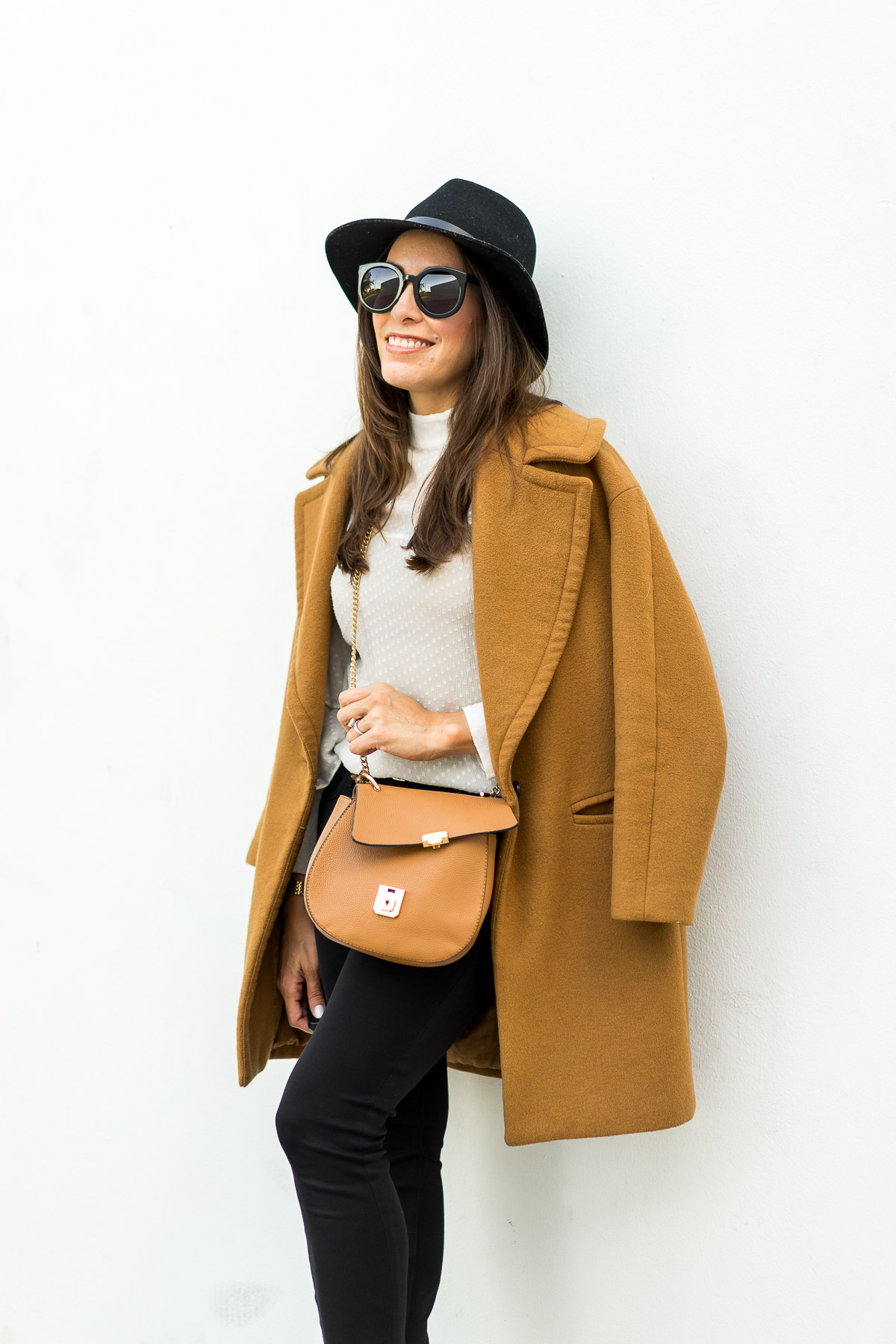 Amanda from A Glam Lifestyle blog shares her winter style look in a tan Zara coat and sheer white blouse with Chloe Drew dupe bag