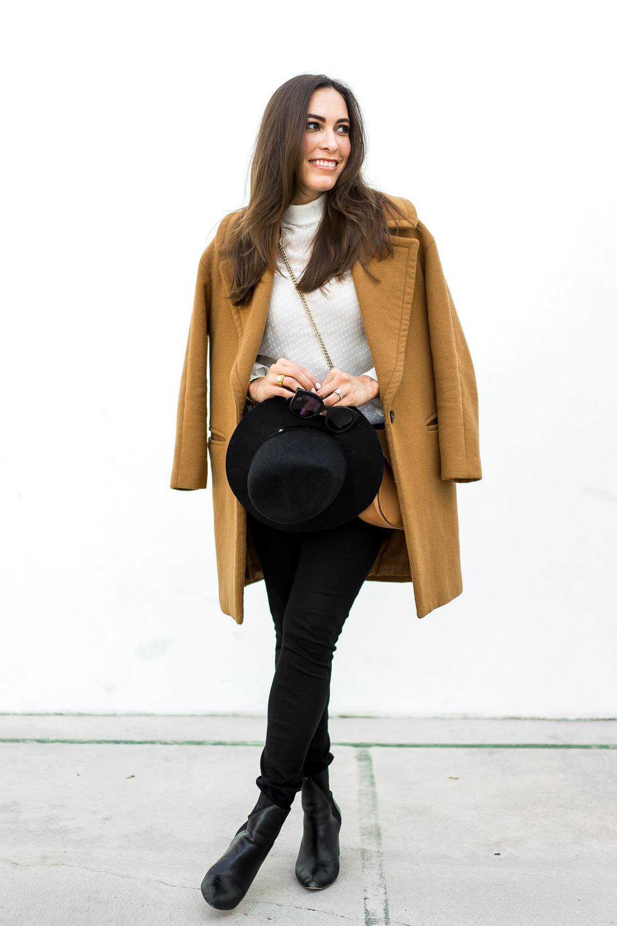 The best winter looks by blogger A Glam Lifestyle in a Zara tan coat carrying Rag and Bone fedora