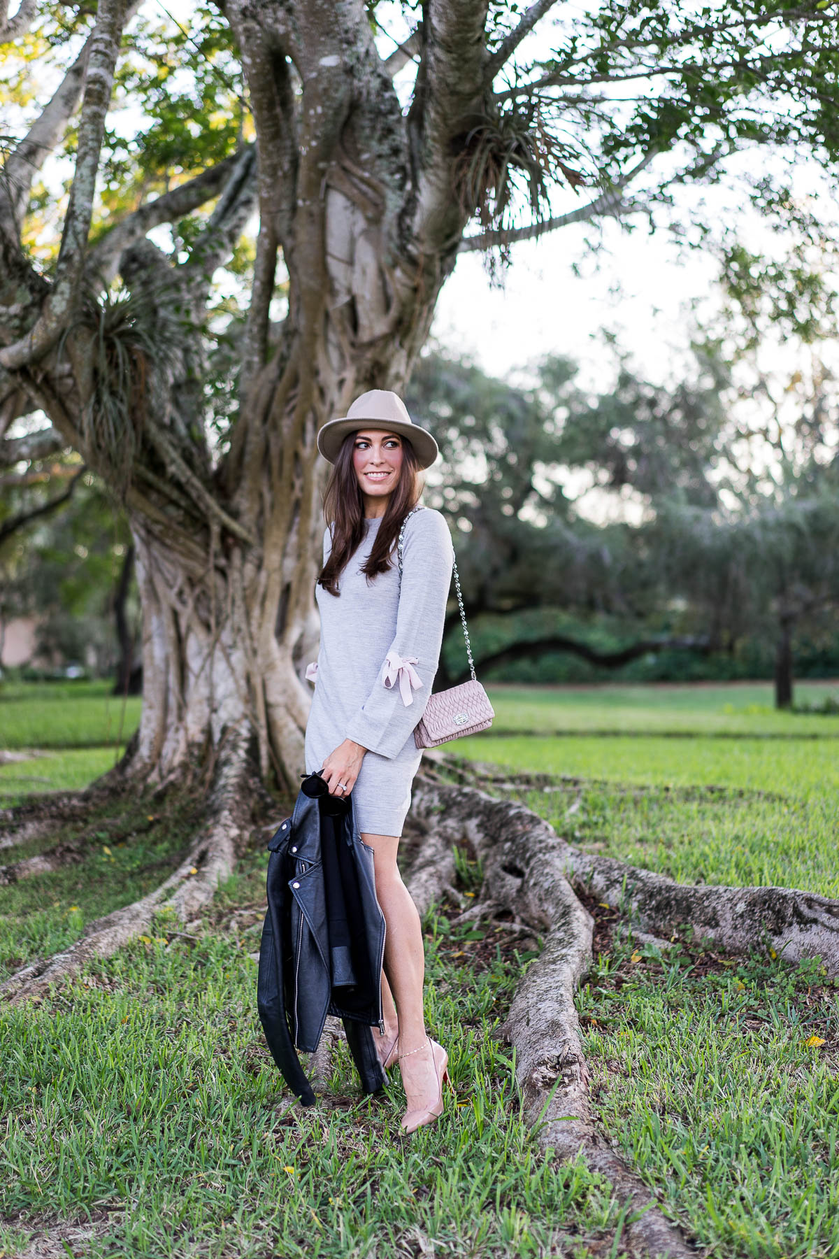 New Years resolutions from fashion blogger Amanda of A Glam Lifestyle while wearing Club Monaco Sohrab grey sweater dress with pink bows and Miu Miu Nappa Crystal bag and Christian Louboutin Pigalle pumps