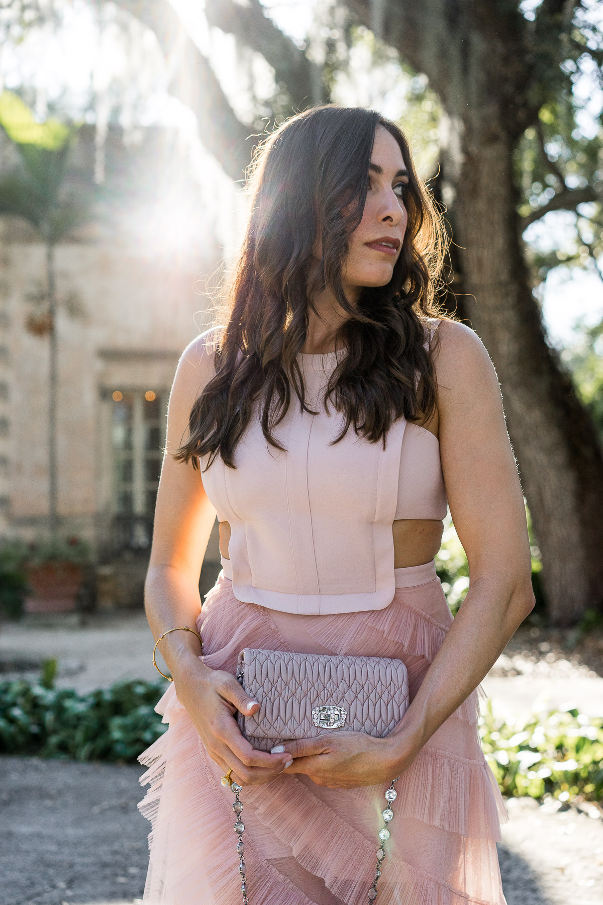 Amanda from A Glam Lifestyle blog wears BCBG blush tulle dress with her Miu Miu bag at Viscaya in Miami