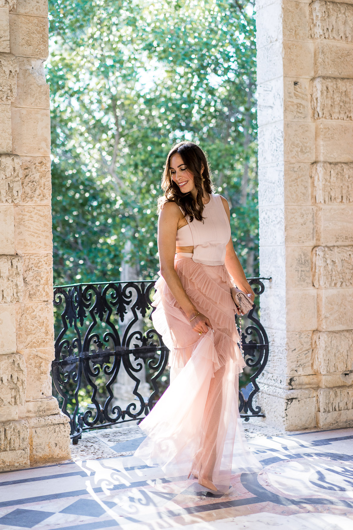 South Florida blogger Amanda from A Glam Lifestyle wears BCBG Avalon blush tulle gown at Viscaya Gardens in Miami