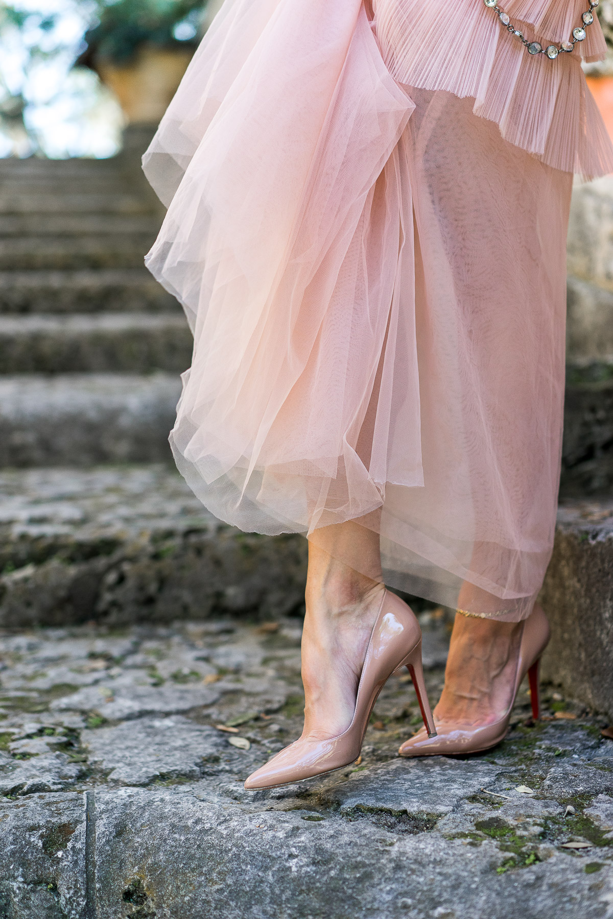 Amanda from A Glam Lifestyle blog wears Christian Louboutin nude Pigalle pumps with BCBG blush tulle dress at Viscaya in Miami