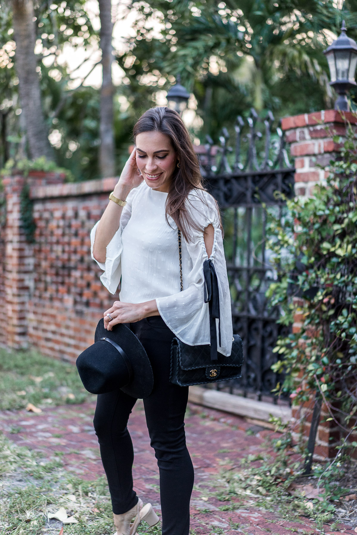 Amanda from A Glam Lifestyle wears Club Monaco bell sleeve top with Rag and Bone fedora and easy black AG legging jeans