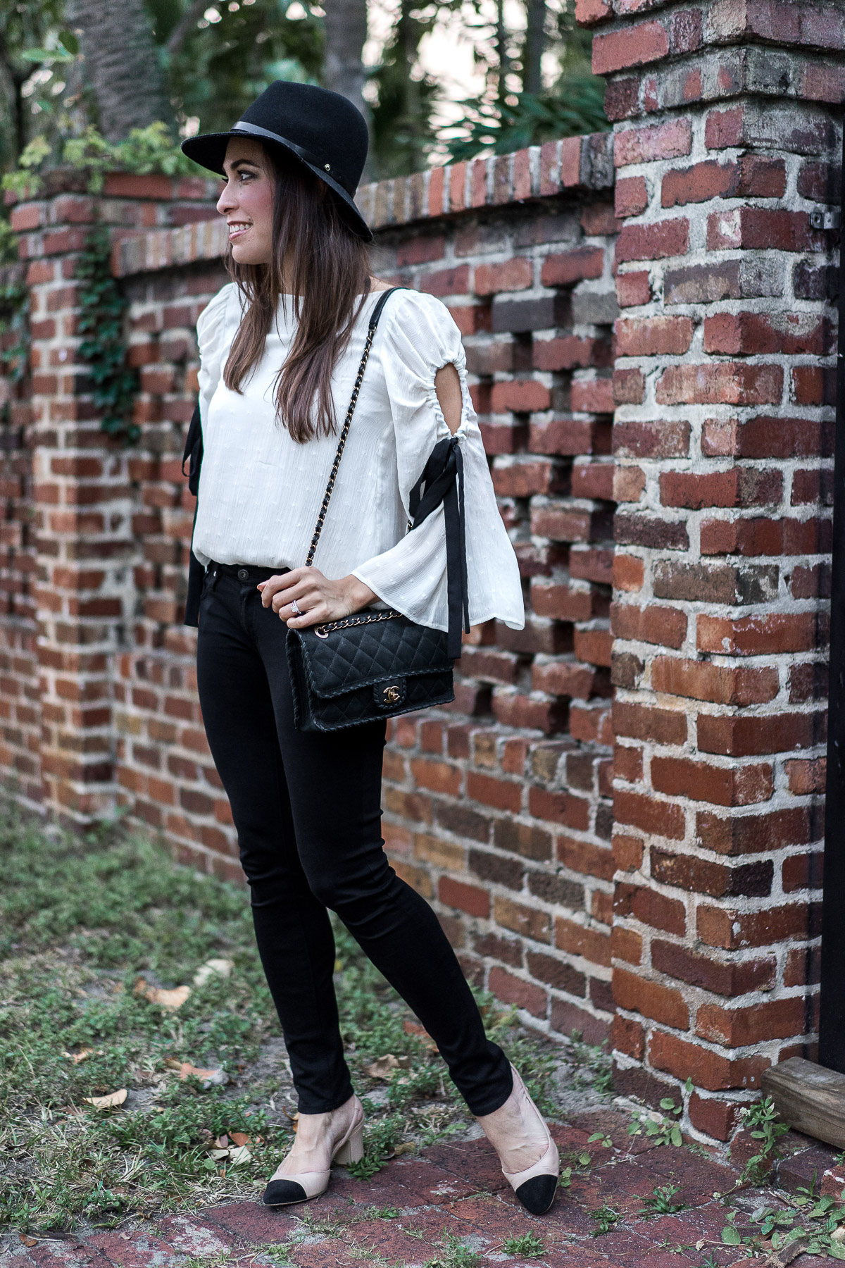 Club Monaco fluttery bell sleeve top with black ribbon details is worn by A Glam Lifestyle blogger Amanda with her favorite AG Legging jeans and Ivanka Trump Liah slingback pumps