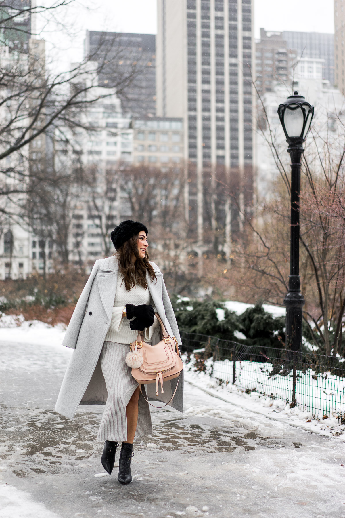 Amanda from A Glam Lifestyle blog styles BCBGeneration grey midi skirt during NYFW with her Chloe Marcie bag and Club Monaco Daylina coat and sweater paired with Sam Edelman military inspired black booties