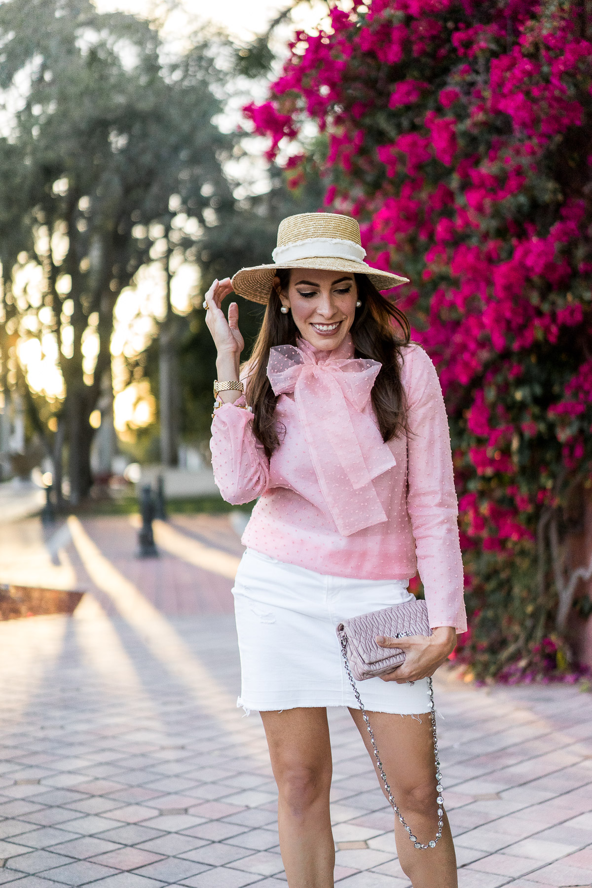 Spring style always includes a pink bow blouse and a chic white denim skirt as worn by A Glam Lifestyle blogger Amanda