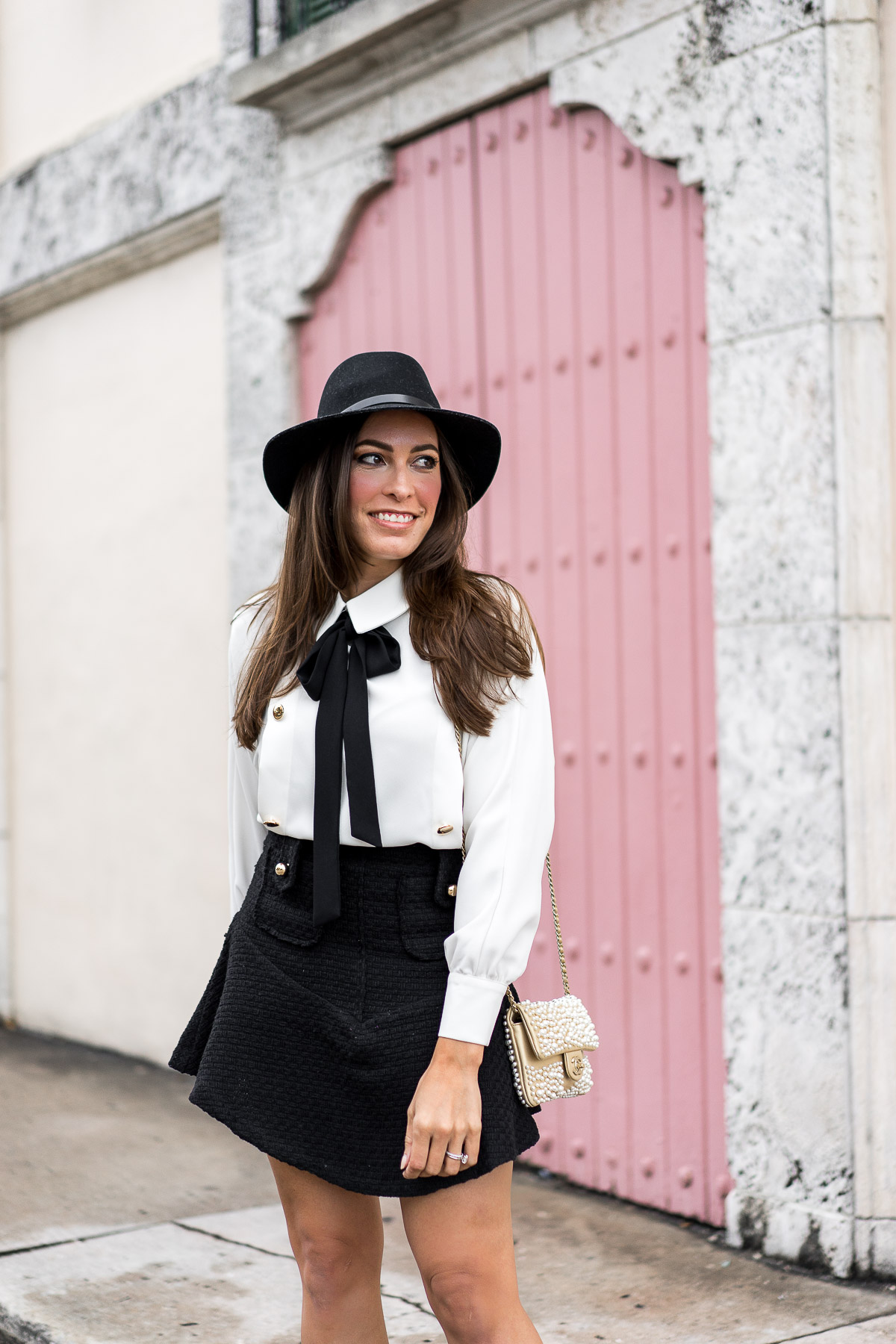 Storets offers affordable fashion like this tweed mini skirt and bow tie shirt worn by blogger Amanda from AGlamLifestyle