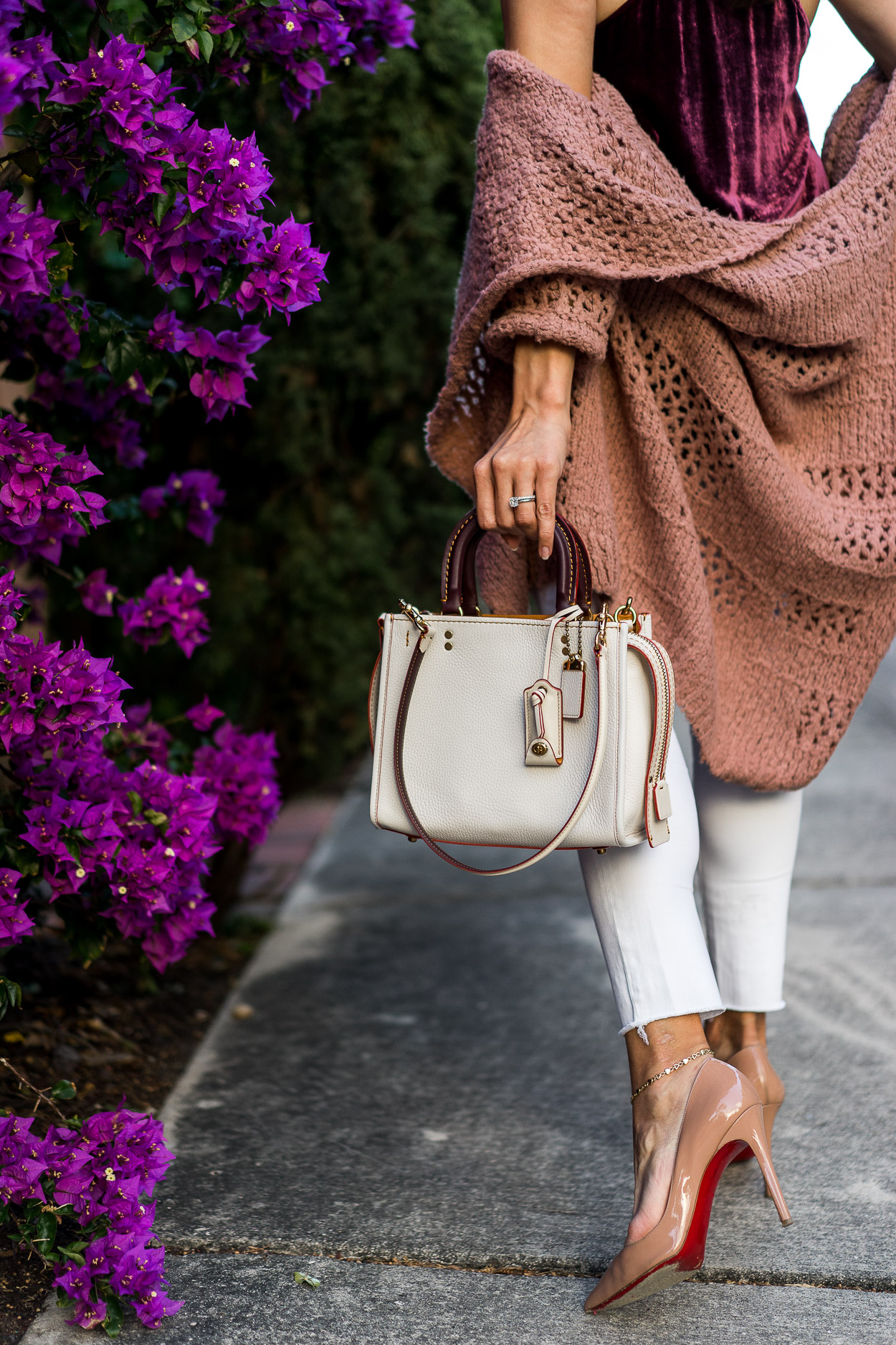 Amanda of AGlamLifestyle blog carries her Coach Rogue bag for Spring