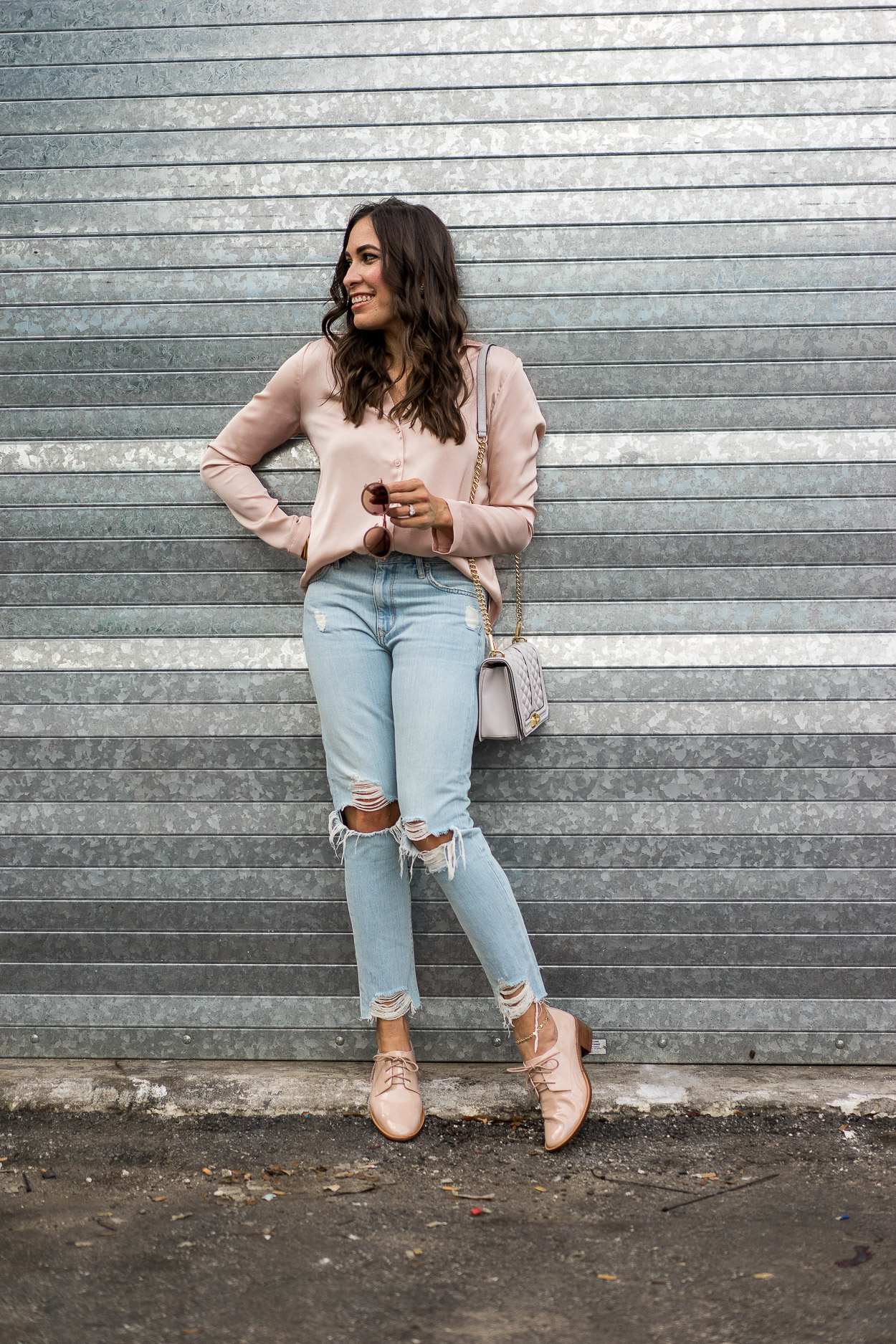 The pajama top trend is booming right now and AGlamLifestyle blogger Amanda shows you how to style it with distressed Lovers + Friends denim and Rebecca Minkoff Love crossbody bag