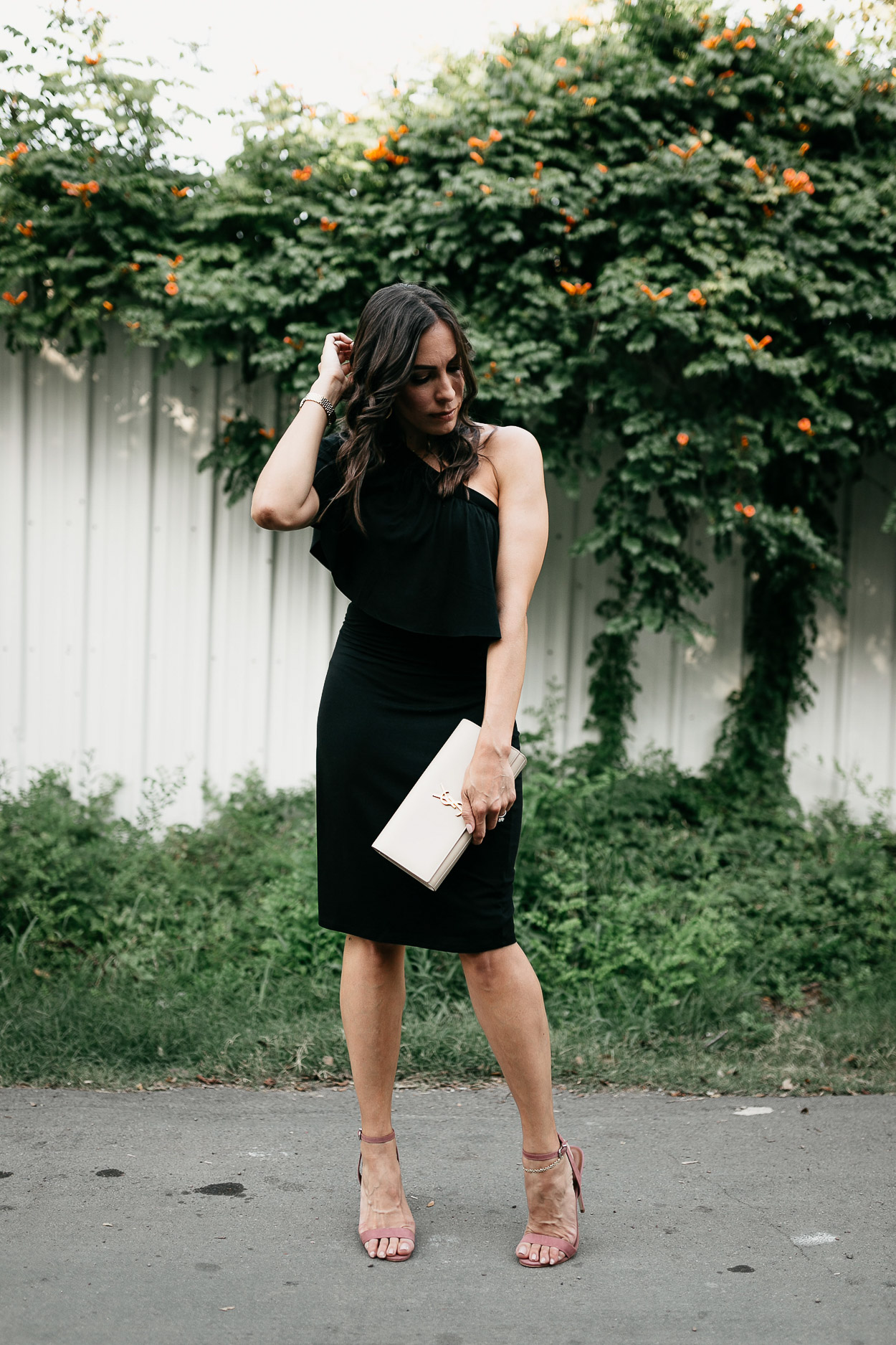 Wear a simple Three Dots black ruffle dress for your next date night as styled by A Glam Lifestyle blogger Amanda with chic details like mauve heels and nude YSL clutch