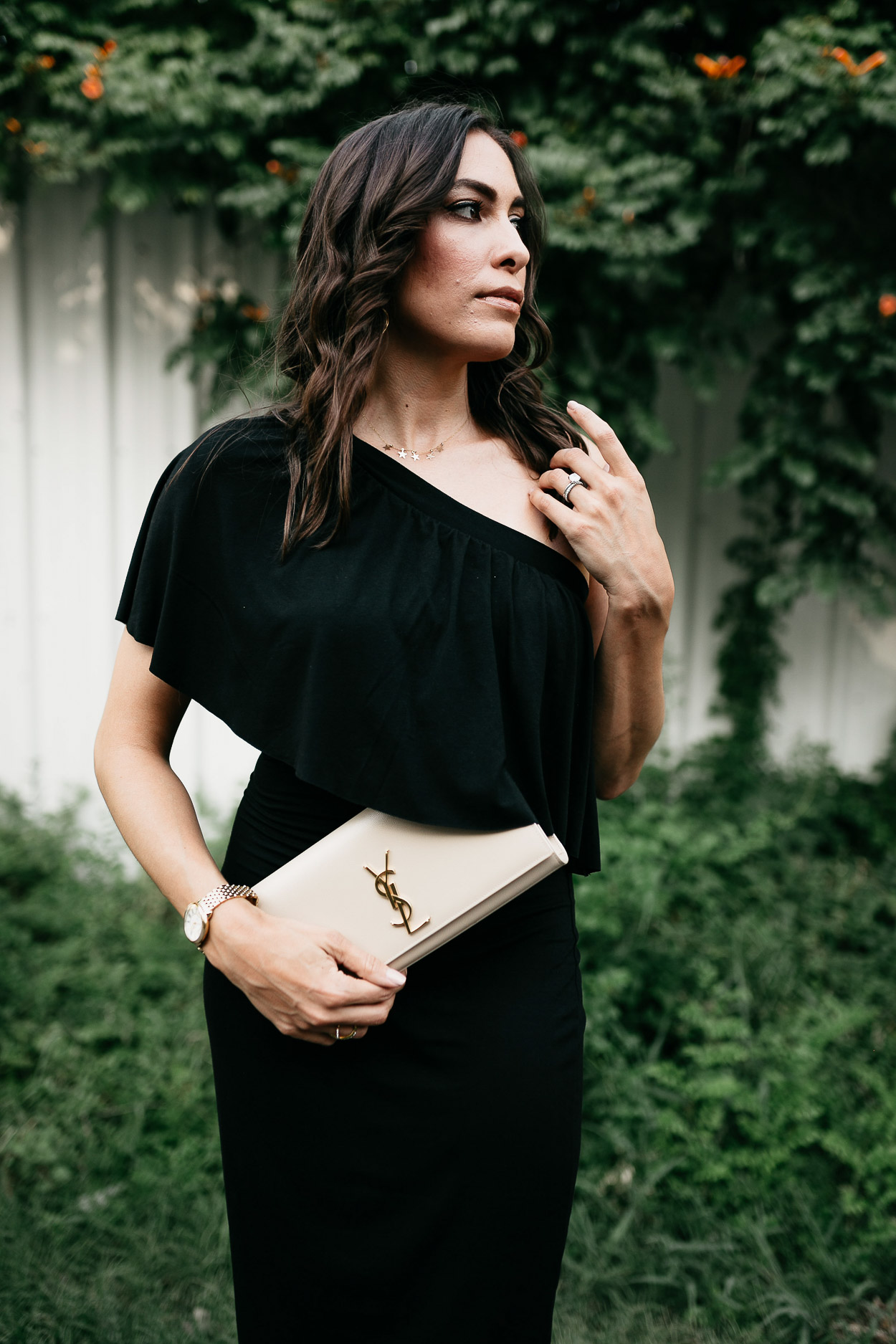 For date night, wear a classic black ruffle dress by Three Dots and compliment it with a nude YSL monogram clutch and mauve heels like fashion blogger Amanda of A Glam LIfestyle