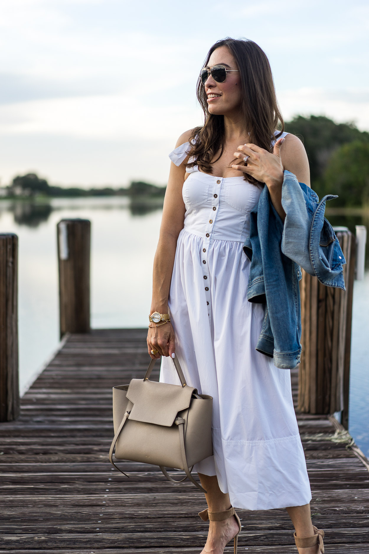 Chic Summer white dress worn by blogger Amanda of A Glam Lifestyle with Celine belt bag and AG Jeans denim jacket