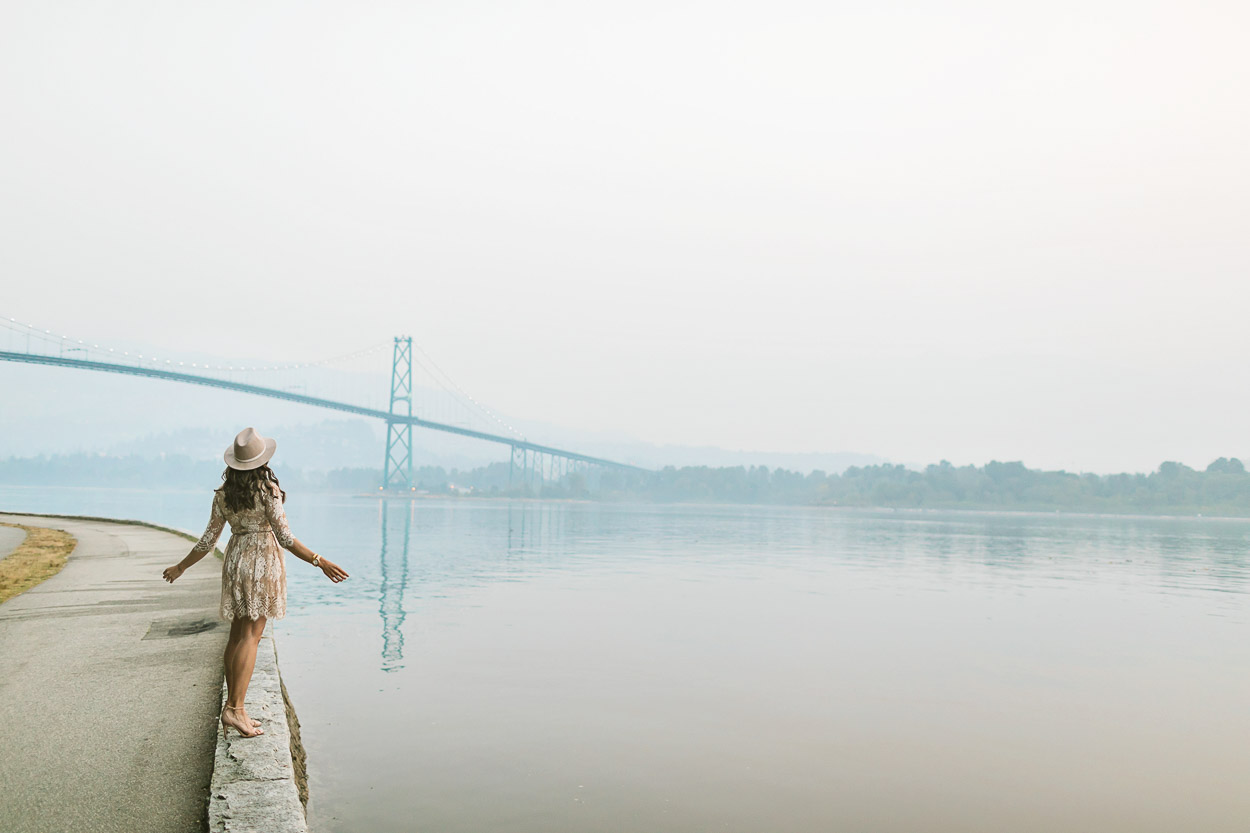 woman visiting the Lions Gate Bridge via Stanley Park