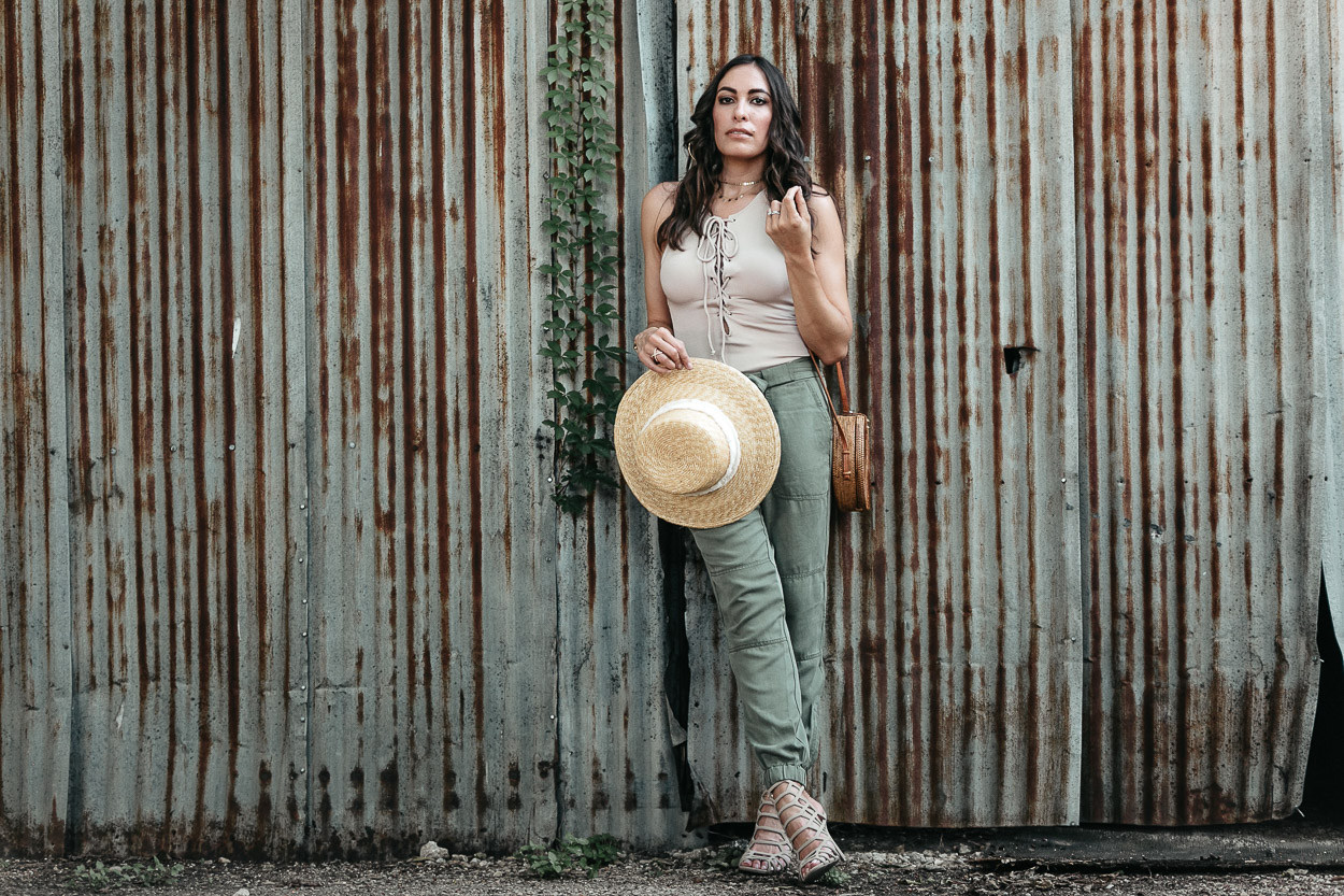 How to style a lace up bodysuit includes wearing it with comfy cargo pants like Amanda of AGlamLifestyle blog