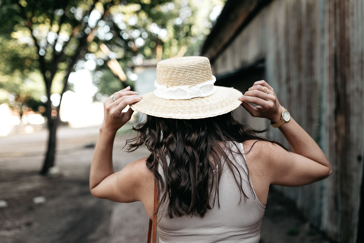 Amanda of A Glam Lifestyle blog grabs her Rag and Bone straw boater hat with her lace up bodysuit for hot Summer days