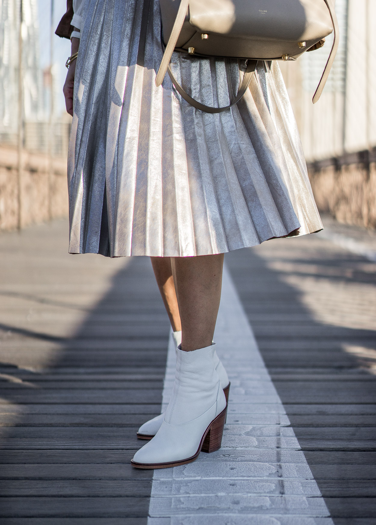 Pair your metallic pleated skirt with white sock booties from Topshop this Fall a la blogger Amanda from A Glam Lifestyle