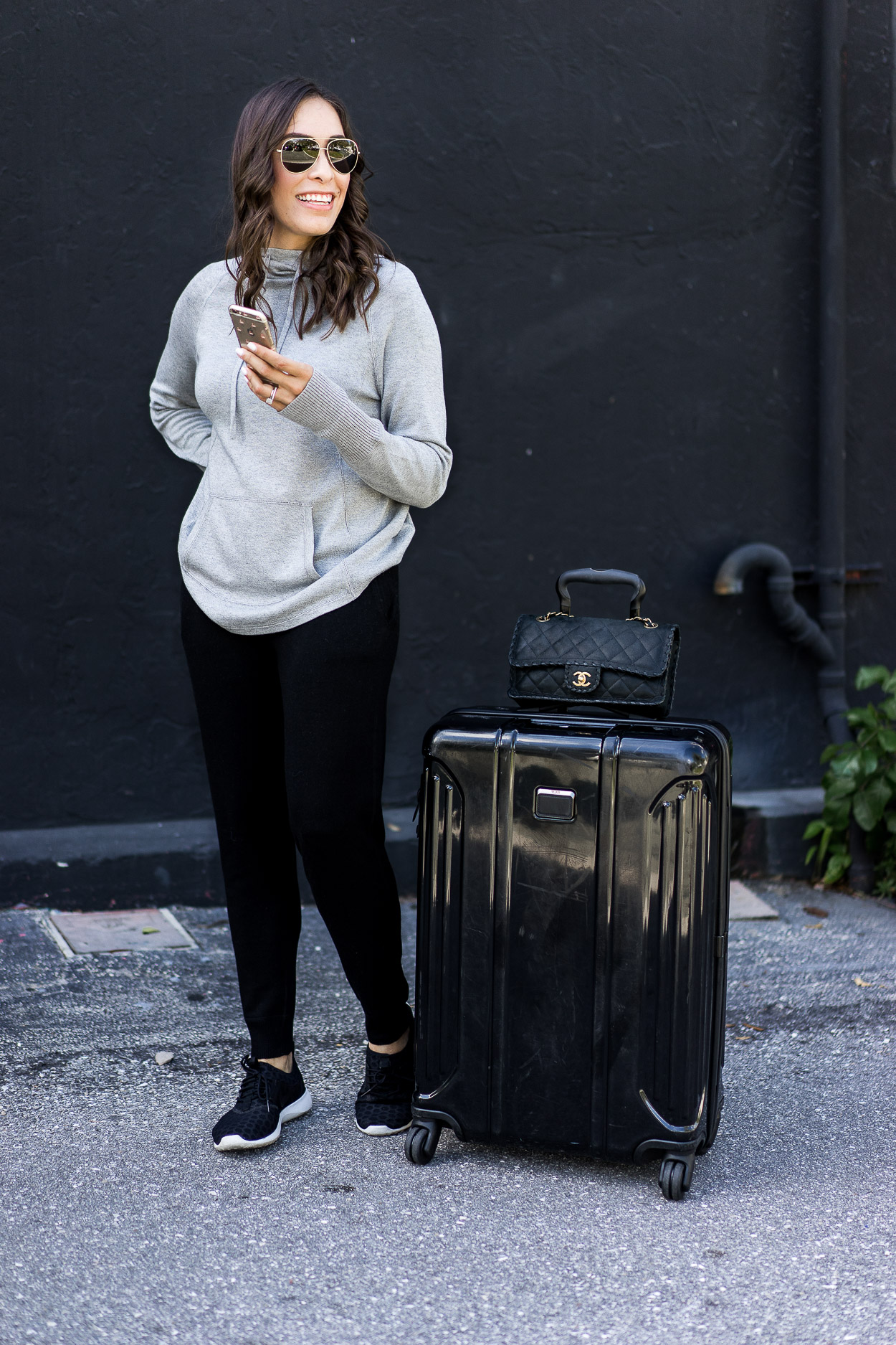 Soft grey cashmere hoodie is worn with Leimere cashmere joggers for easy travel style by Amanda of A Glam Lifestyle blog