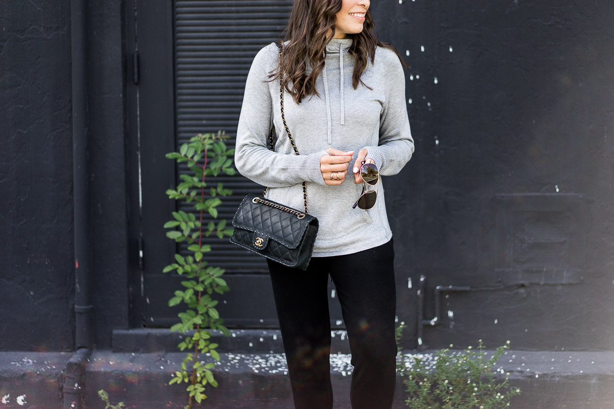 Grey cashmere hoodie is simple airport style when paired with classic Chanel bag and Warby Parker aviators like Amanda of A Glam Lifestyle blog